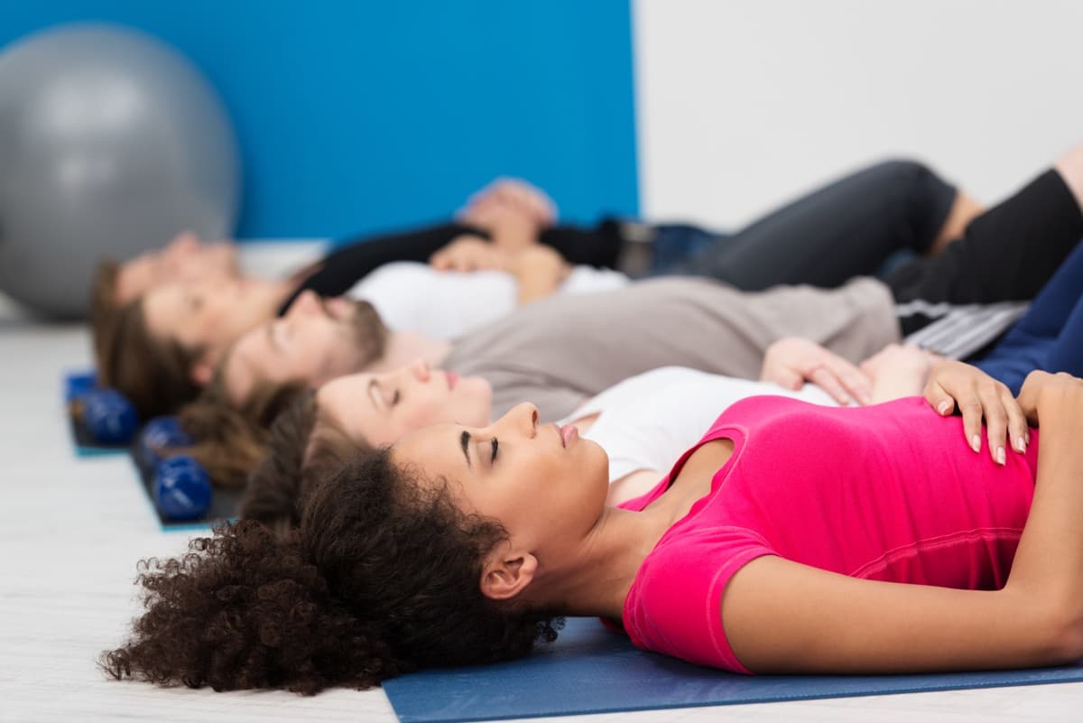 People in a lying down meditation posture.